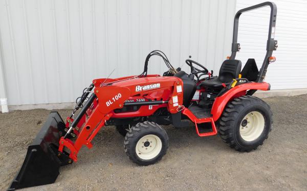 Image of Red lawn tractor with front-end loader